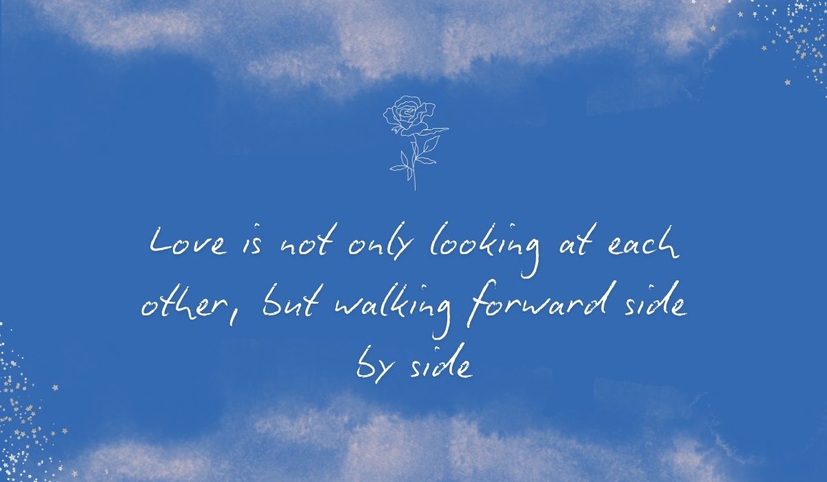 Rich royal blue watercolor background with subtle stardust detailing in the corners and a white line-art rose accenting the cursive marriage sentiment, "Love is not only looking at each other, but walking forward side by side"