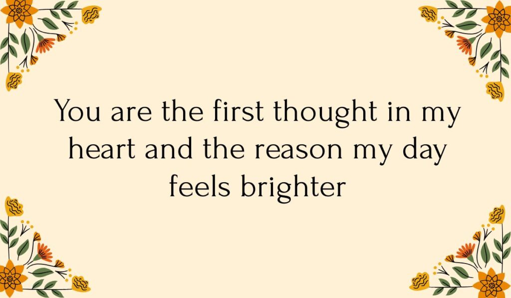 Cream-colored card decorated with colorful orange and yellow floral vine illustrations in each corner, featuring sweet best morning messages for him: "You are the first thought in my heart and the reason my day feels brighter".