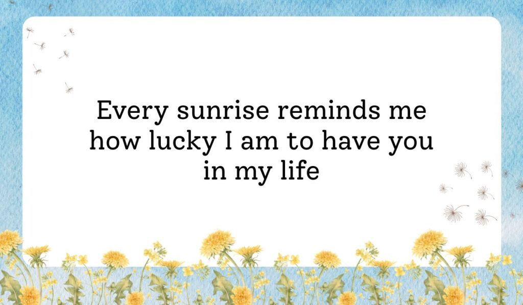 Clean white card framed by a vibrant light blue sky texture background with delicate dandelion flowers along the bottom border, showcasing thoughtful best morning messages for him: "Every sunrise reminds me how lucky I am to have you in my life".