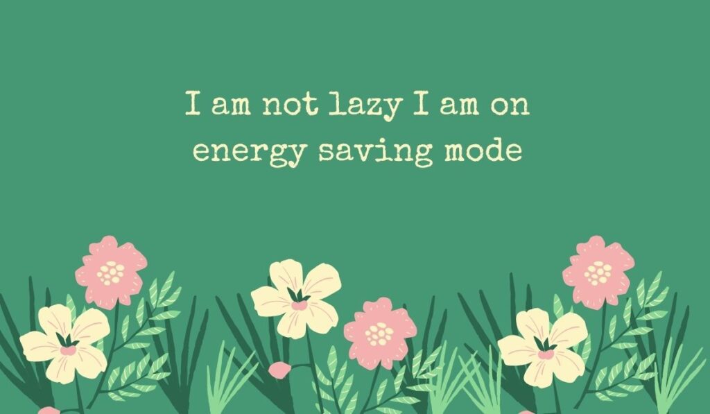 Deep sage green card featuring a row of simple pink and cream wildflowers along the bottom, displaying typed, humorous funny quotes for the day at work: "I am not lazy I am on energy saving mode".