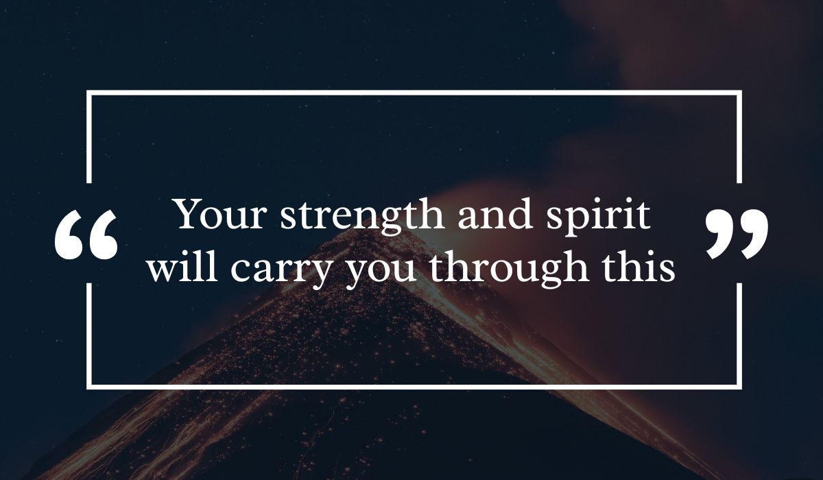 Dramatic dark night sky background featuring a lit volcanic peak at night, centered with a white quotation box highlighting powerful greetings for get well wishes: "Your strength and spirit will carry you through this".