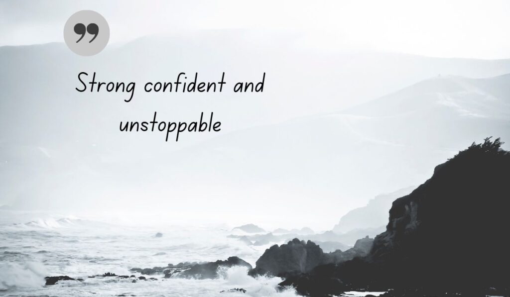 Atmospheric black and white coastal image of crashing ocean waves against rocky cliffs, centered with a thin, delicate gray circle and a dark green quotation icon framing the handwritten literary text, "Strong confident and unstoppable".