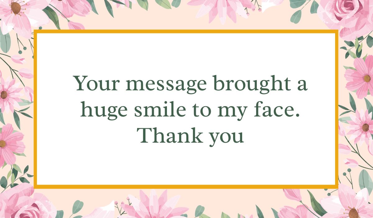 Bright white card enclosed by an elegant border of pink watercolor roses and green leaves with a thin gold inner frame, displaying a cheerful thank you message for all the birthday wishes: "Your message brought a huge smile to my face. Thank you".
