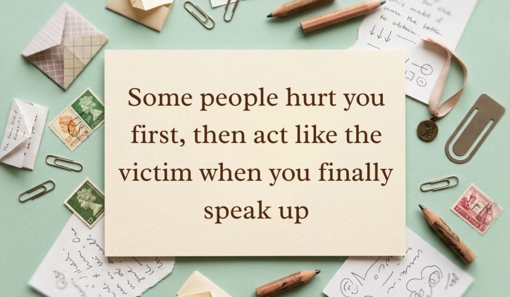 Soft mint green vintage desk layout with scattered postage stamps, envelopes, and pencils featuring toxic playing victim quotes reading, "Some people hurt you first, then act like the victim when you finally speak up"